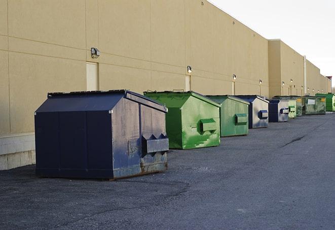 construction workers toss wood scraps into a dumpster in Metairie LA